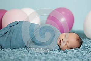 Portrait of newborn baby girl with balloons