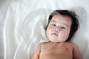 Portrait of Newborn baby Lying Down on a Bed