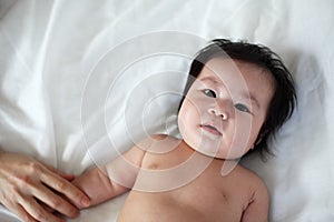 Portrait of Newborn baby Lying Down on a Bed