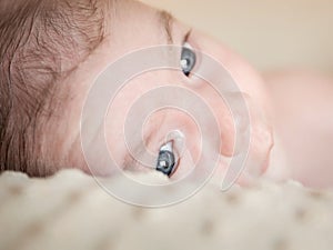 Portrait of newborn baby lying down over a blanket