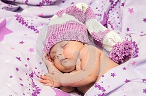 Portrait newborn baby sweetly a sleep in long gnome hat