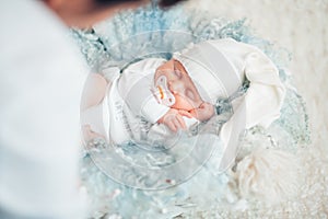 Portrait of a newborn with a pacifier