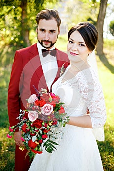 Portrait of newlyweds couple outdoors, summer.