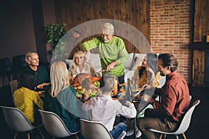 Portrait of nice attractive cheerful adorable positive family parents grandparents grandchildren enjoying cutting