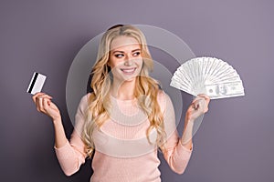 Portrait of nice attractive lovely cheerful cheery wavy-haired girl client holding in hands fan of 100 usd bank plastic