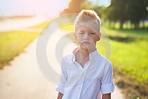 Portrait of a nice child on the road in the sunny day