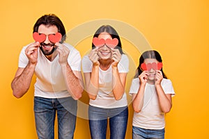 Portrait of nice cute attractive funny cheerful cheery people closing covering eyes with red paper cards over