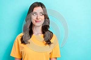 Portrait of nice girlish pretty girl with curly hairdo dressed yellow t-shirt look empty space isolated on turquoise