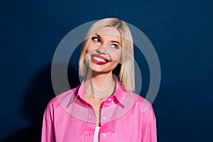 Portrait of nice gorgeous positive girl with bob hairdo wear stylish shirt look at discount empty space isolated on dark