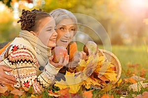 Portrait of nice grandmother of granddaughter in autumn