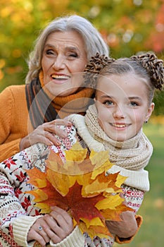 Portrait of nice grandmother of granddaughter in autumn