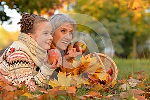 Portrait of nice grandmother of granddaughter in autumn