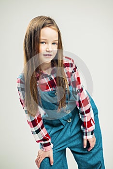 Portrait of a nice little girl. kid smiles. child model posing in the studio. fashion photography
