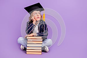 Portrait of nice smart bored schoolboy wearing hat thinking copy space  over purple violet color background