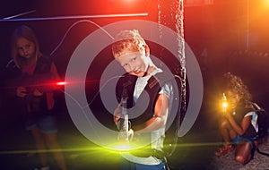 Portrait of nice tweenager boy with laser gun photo