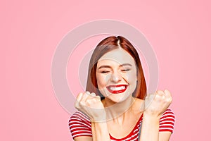 Portrait of nice vivid girlish red straight-haired happy smiling toothy young girl celebrating lottery victory winning