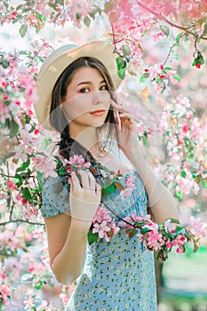 Portrait of nice young girl  walk with bicycle, take a rest in blooming appple garden