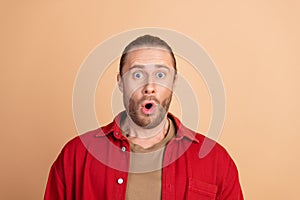 Portrait of nice young man open mouth stare wear red shirt isolated on beige color background