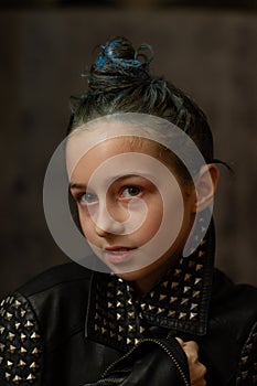 Portrait of nine year old girl. Teenager with blue strands on her hair. A series of photos of a girl of 8 or 9 years old