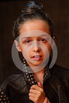 Portrait of nine year old girl. Teenager with blue strands on her hair. A series of photos of a girl of 8 or 9 years old