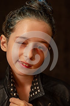 Portrait of nine year old girl. Teenager with blue strands on her hair. A series of photos of a girl of 8 or 9 years old