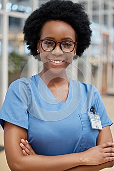 Portrait, nurse and black woman with arms crossed, smile or happy in hospital. African medical professional, confidence