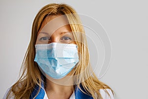 Portrait Of Nurse In Medical Mask On A Blue Background.