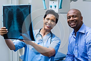 Portrait of nurse and patient discussing x-ray