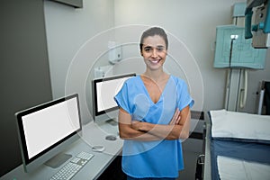 Portrait of nurse standing with arms crossed