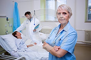 Portrait of nurse standing with arms crossed