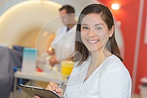 Portrait nurse taking notes in radiology department