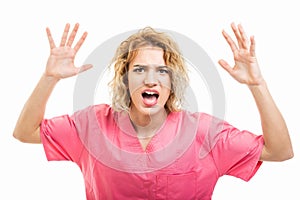 Portrait of nurse wearing pink scrub screaming out loud