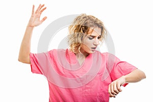 Portrait of nurse wearing pink scrubs making late gesture