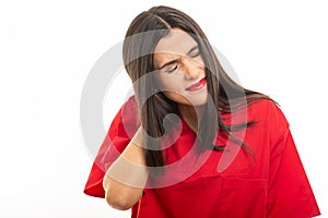 Portrait of nurse wearing scrubs making back head ache gesture