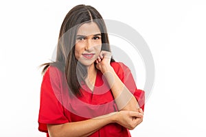 Portrait of nurse wearing scrubs making elbow pain gesture