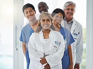 Portrait, nurses and team of doctors in line, smile and standing together in hospital. Face, healthcare and medical