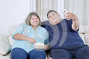 Portrait of obese Asian couple taking a selfie