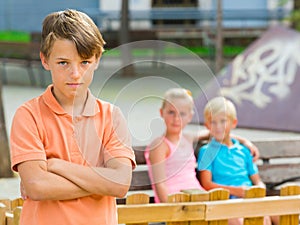 Portrait of offended boy which is standing outside of the company