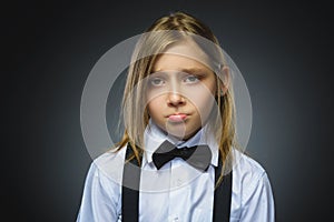 Portrait of offense girl isolated on gray background. Negative human emotion, facial expression. Closeup