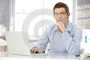 Portrait of office worker with laptop