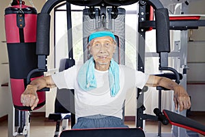 Portrait of old Asian man working out sweatily