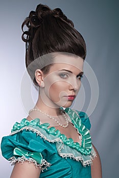 Portrait of old fashioned girl in cyan dress