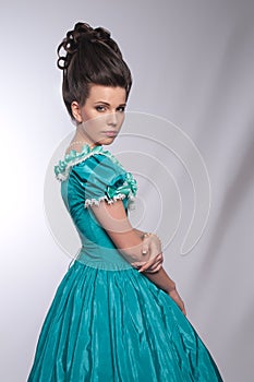 Portrait of old fashioned girl in cyan dress