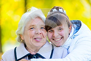 Portrait of an old grandmother and a young granddaughter