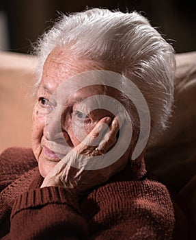 Portrait of old gray-haired sad woman