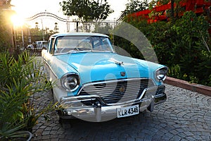 Old retro blue commander vintage car parked at driveway of a house, outdoor bright sun natural background, vintage