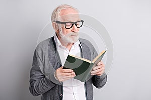 Portrait of old white hair optimistic man read book wear spectacles dark sweater isolated on grey background