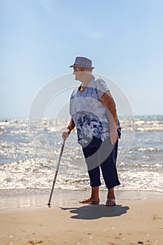 Portrait of an old woman on the background of the sea