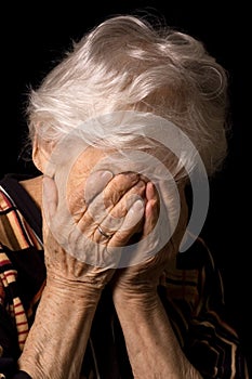 Portrait of the old woman a black background