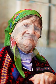 Portrait of old woman in coloured wear